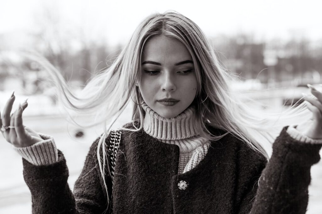 black and white photo of a blonde woman with the wind blowing her hair