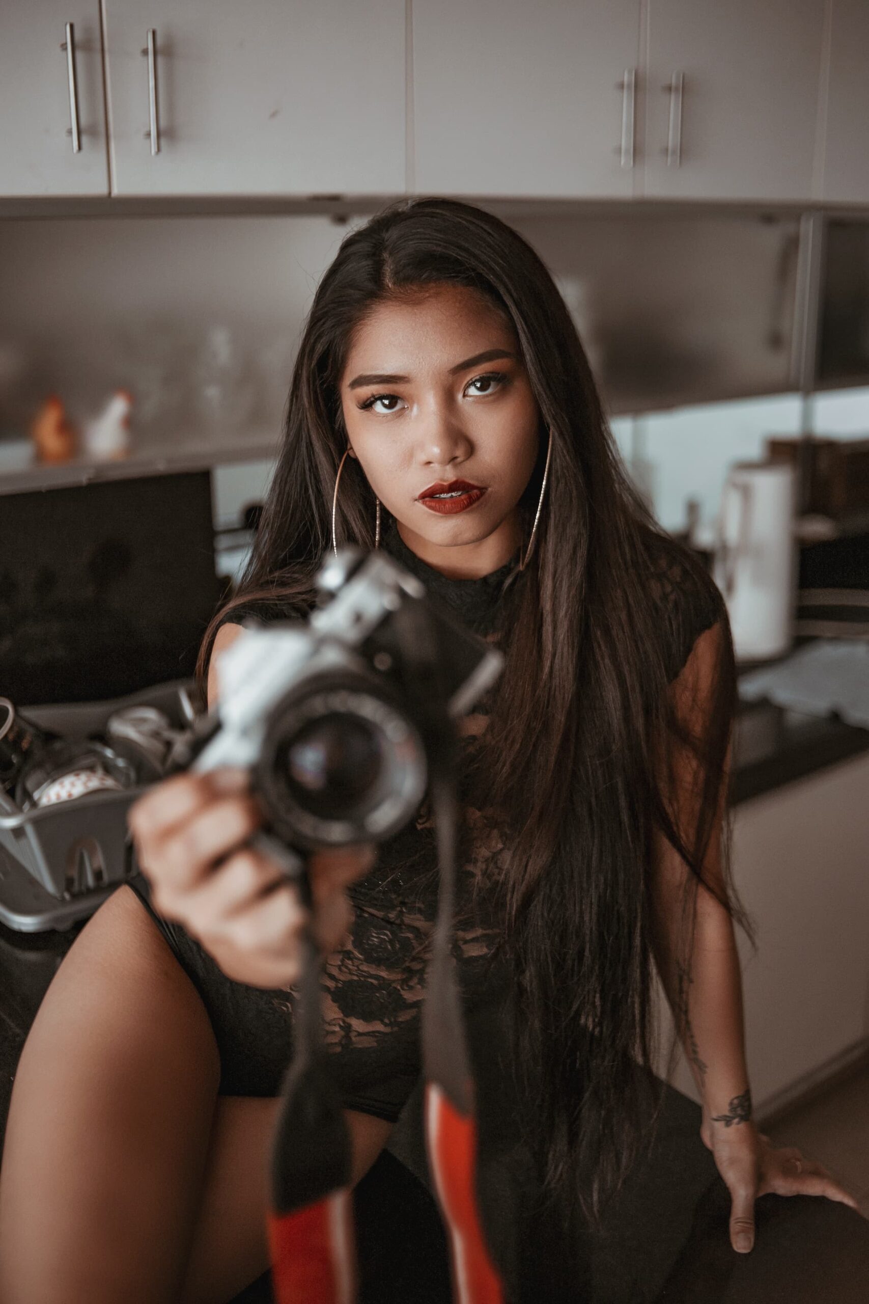 beautiful asian woman holding a camera