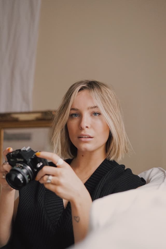 blonde women holding a camera