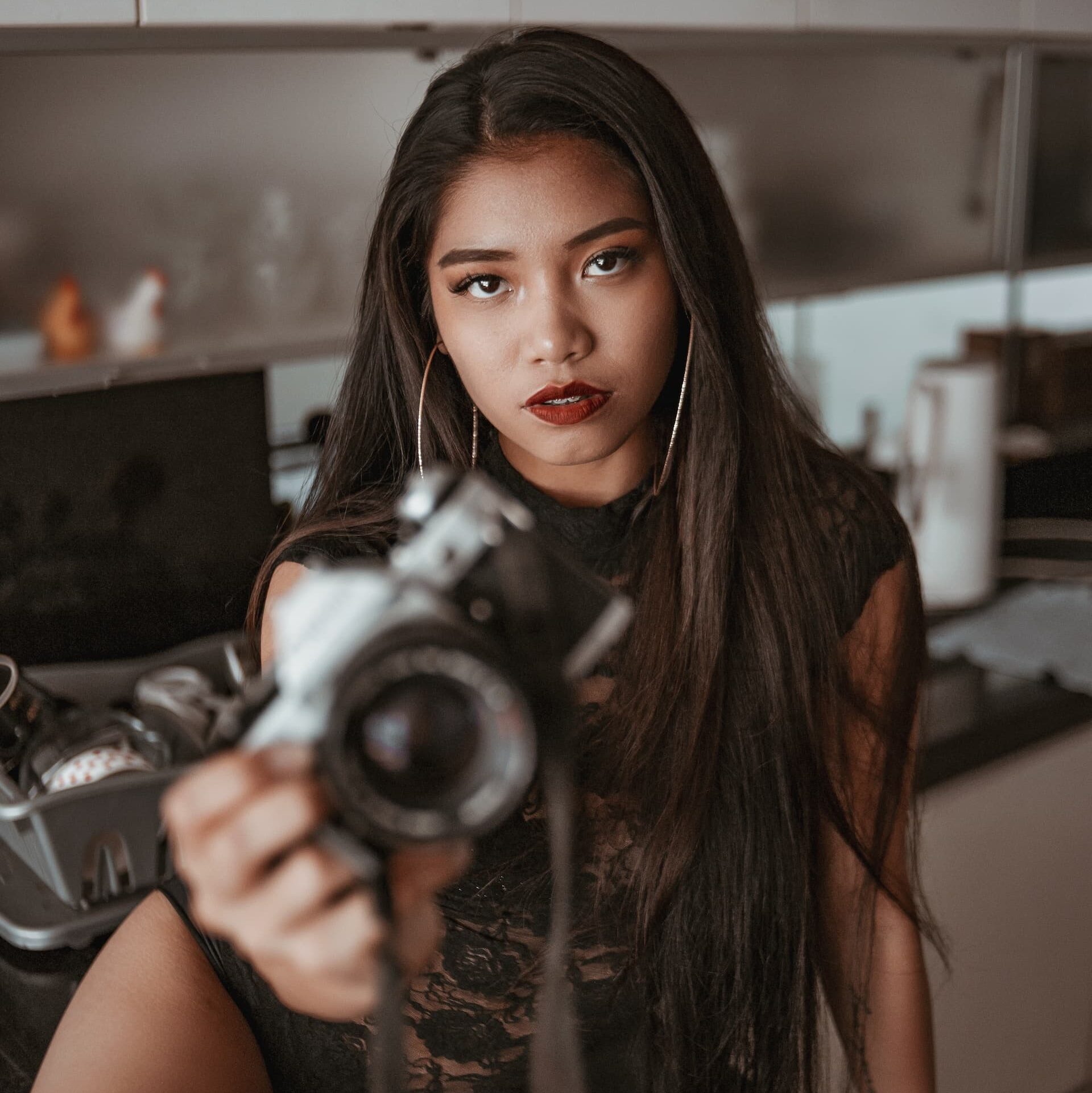 beautiful asian woman holding a camera